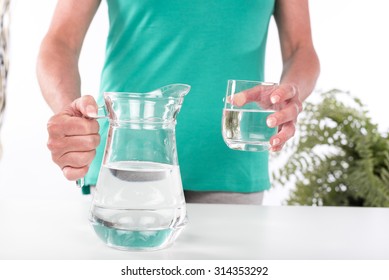 Woman Holding A Pitcher And A Glass Of Water