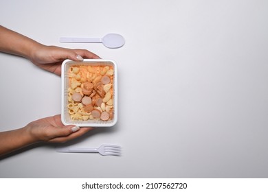 Woman Holding Plastic Box Of Frozen Macaroni Pasta With Cheese Sauce.