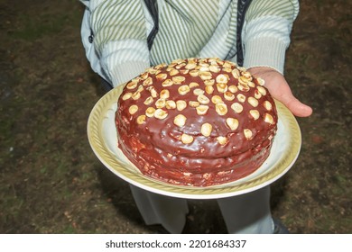 Woman Holding Plate With Delicious Chocolate Pie On Black Background, Closeup