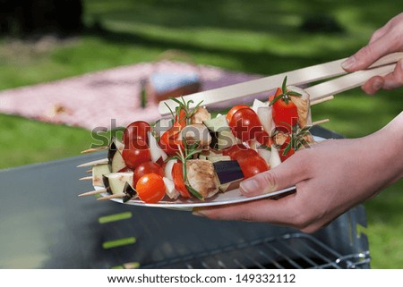 A woman holding a plate with vegetable sticks