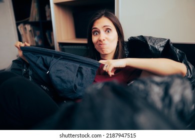 
Woman Holding Plus Size Pants Getting Rid Of Old Clothes. Hoarder Girl Throwing Away Used Worn Item Switching To A Minimalist Wardrobe
