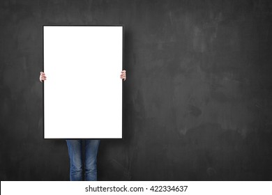 Woman Holding A Poster Over A Blackboard