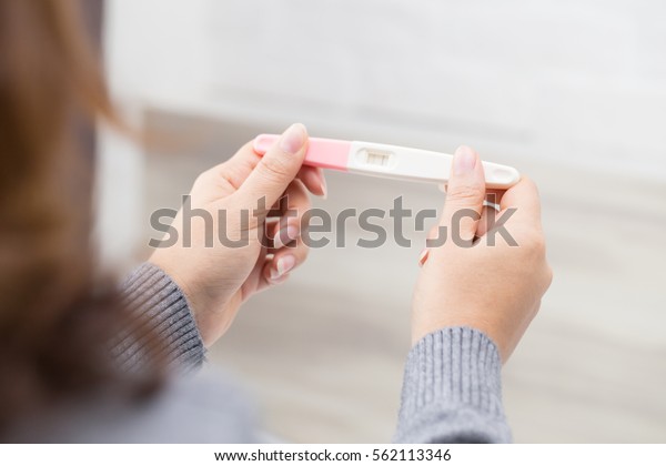 Woman holding pregnancy test, New life and new\
family concept.