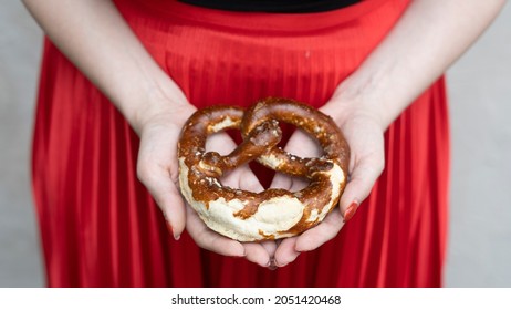 Woman Holding A Pretzel - Bavarian Culture 