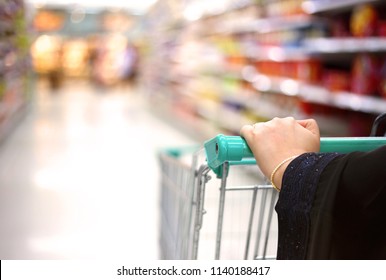 A Woman Holding Pushcart Shopping In Supermarket In Mall In Saudi Arabia Gulf Middle East