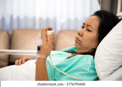 Woman holding and pushing hand emergency button in hospital patient room; Hand press to call Nurse for emergency case	