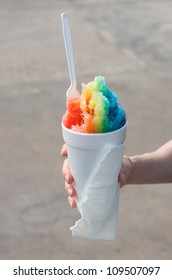 Woman Holding A Rainbow Snow Cone In A Styrofoam Cup