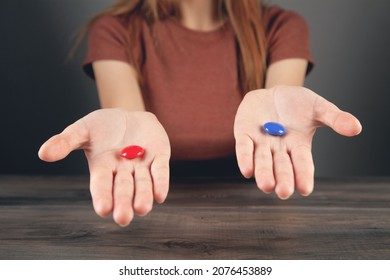 Woman Holding Red And Blue Pill In Her Hands