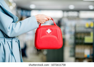 Woman Holding Red First Aid Kit At The Farmacy Store