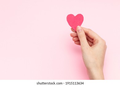 Woman Holding Red Heart Cards In Hands On Pink Background, Top View