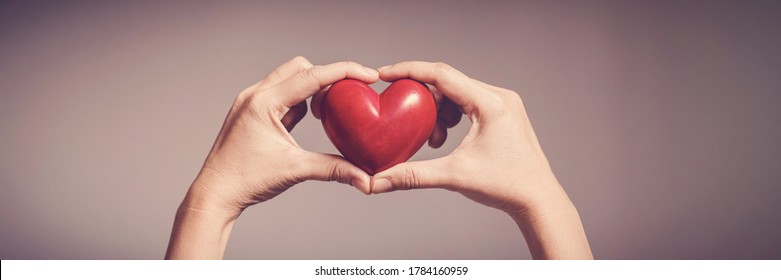 Woman holding red heart, health insurance, donation, happy charity volunteer concept, world mental health day, world heart day, self care, CSR, csv concept - Powered by Shutterstock