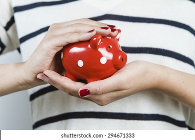 Woman Holding Red Piggy Bank