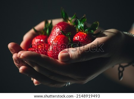 Similar – Woman holds strawberries in her hands