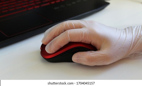 Woman Is Holding Red Stylish Mouse By Her Hand, Close Up. Doctor Or Nurse Or Office Worker Using Protective Gloves While Using Computer Mouse Working At PC At Hospital Or Work In Order To Stop