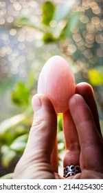 Woman Holding A Rose Quartz Yoni Egg