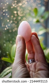 Woman Holding A Rose Quartz Yoni Egg