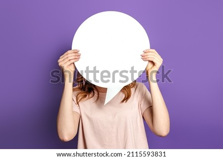 woman holding a round information piece of paper dialog. Student with blank white speech bubble isolated on purple studio background. copy space