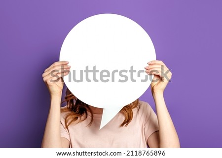 woman holding a round information piece of paper dialog. Student with blank white speech bubble isolated on purple studio background. copy space