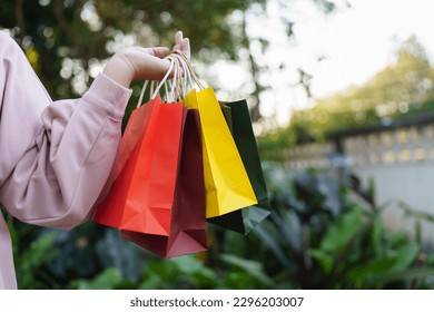 Woman holding sale shopping bags. consumerism shopper lifestyle concept in the shopping mall. shopping center with shopping bag.