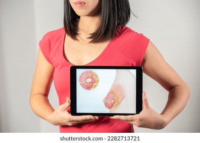 Woman holding screen with drawing of breast cancer - Shutterstock ID 2282713721