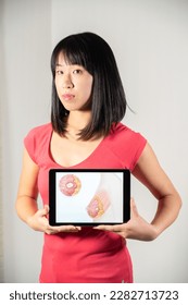 Woman holding screen with drawing of breast cancer - Shutterstock ID 2282713723