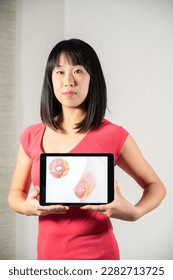 Woman holding screen with drawing of breast cancer - Shutterstock ID 2282713725