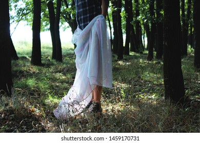 Woman Is Holding A See Through Fabric Down Her Legs. Sunlight Rays Falling Down In The Woods, Wearing Snickers.
Alone/lost In The Woods