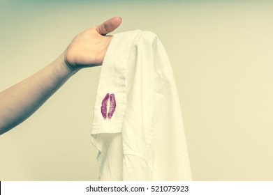 Woman Holding A Shirt With Red Kiss Lipstick Of Her Unfaithful Husband - Retro Style