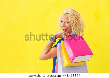 Woman holding shopping bags over her shoulder