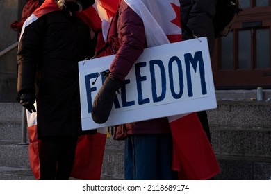 Woman Holding Sign Freedom During Peaceful Protest Against Covid 19 Mandates And Restrictions And Mandatory Vaccination In Toronto City Downtown.