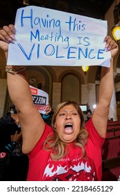 A Woman Holding A Sign Protests During The Los Angeles City Council Meeting Tuesday, Oct. 25, 2022 In Los Angeles. 