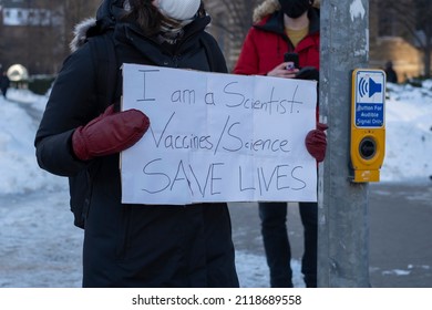 Woman Holding Sign I'm A Scientist Vaccines Science Save Lives At Peaceful Protest Against Covid 19 Mandates And Restrictions And Mandatory Vaccination In Toronto City Downtown.