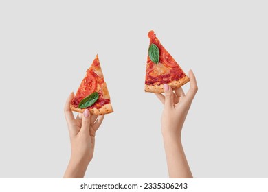 Woman holding slices of tasty pizza on white background - Powered by Shutterstock