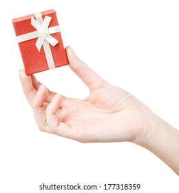 Woman Holding Small Red Gift Box With Fingers Closeup Isolated On White