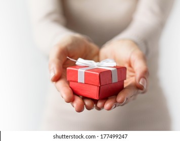 Woman Holding Small Red Present Box In Hands.