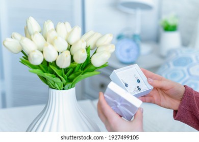 Woman Holding Small White Gift Box And Greeting Card With Bouquet Of White Tulips Flowers On Valentines Day.  