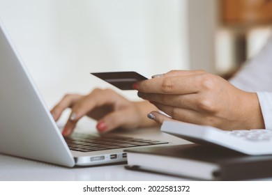 Woman Holding Smart Phone And Credit Card For Shopping Online.Blank Screen Monitor For Graphic Display Montage.Pay For Goods By Credit Card Through A Smartphone .