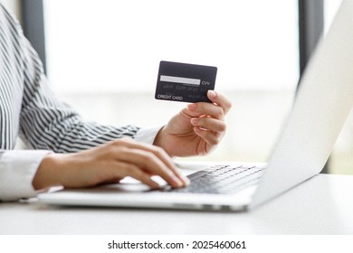 Woman Holding Smart Phone And Credit Card For Shopping Online.Blank Screen Monitor For Graphic Display Montage.Pay For Goods By Credit Card Through A Smartphone .