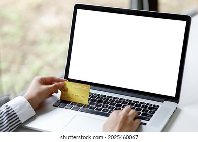 Woman Holding Smart Phone And Credit Card For Shopping Online.Blank Screen Monitor For Graphic Display Montage.Pay For Goods By Credit Card Through A Smartphone .