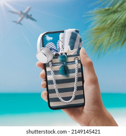 Woman Holding A Smartphone With Beach Bag And Accessories Inside, Travel And Apps Concept