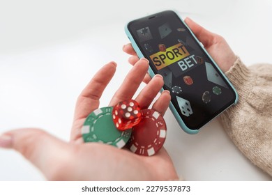woman holding smartphone betting. online sport gambling application on her mobile phone. - Shutterstock ID 2279537873
