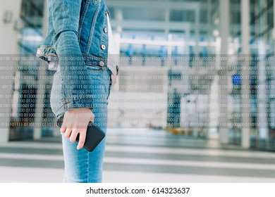 Woman holding a smartphone - binary code concept and future technology, artificial intelligence. Big data technology, blue concept background, high speed digital internet. 