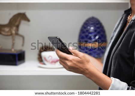 Woman is holding smartphone close up