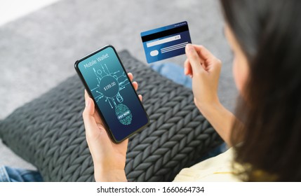 Woman Holding Smartphone And Credit Card With Scanning Biometric Fingerprint For Approval To Access For Payment Mobile Banking On Application Wallet. 