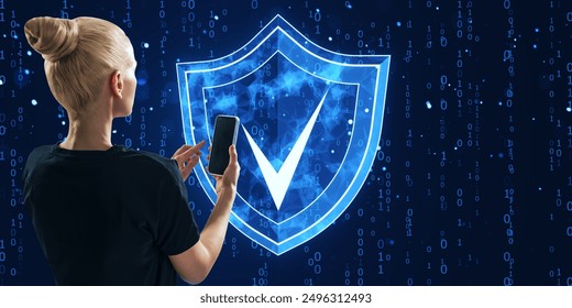 Woman holding a smartphone with a digital shield and checkmark icon on a binary code background. Concept of cyber security and data protection