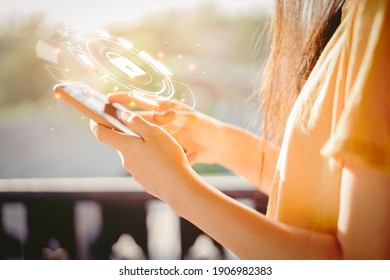 A woman holding a smartphone is entering a password to protect the cybercrime and the Internet privacy lock Concept of security in communication technology, information, privacy, antivirus. - Shutterstock ID 1906982383