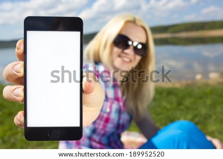 woman holding smartphone in hand