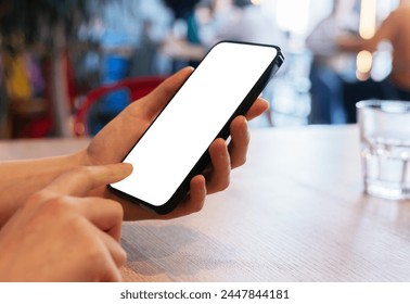 A woman holding a smartphone, interacting with a clean, clear screen. The mockup offers space for digital advertisement or app display.