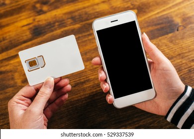 Woman Holding Smartphone And New SIM Card, Mock Up Image