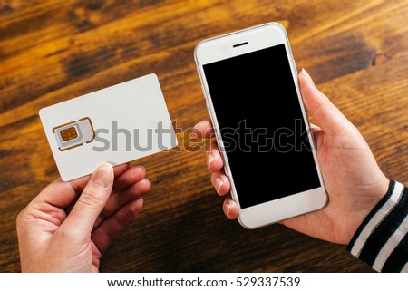 Woman holding smartphone and new SIM card, mock up image
